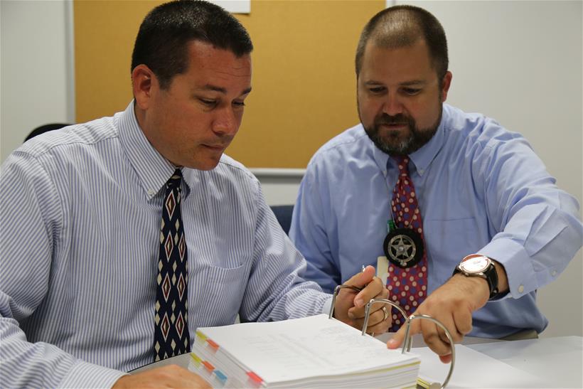 detectives going over paperwork